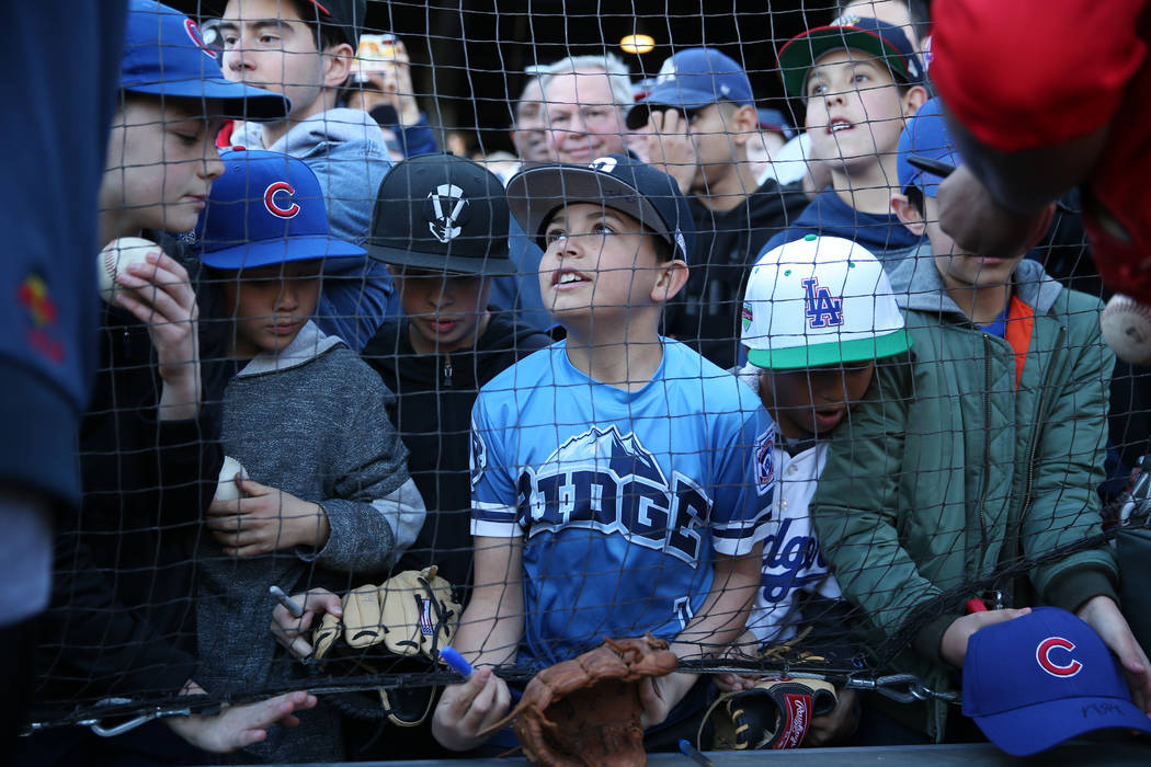 Angelo Giorgi-Ugarte, center, 10, waits for an autograph from Chicago Cubs player Kris Bryant d ...