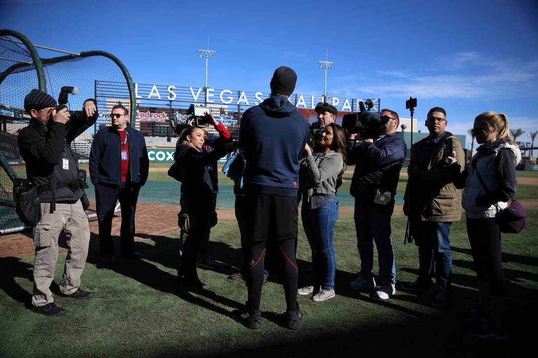 Chicago Cubs player Kris Bryant holds is interviewed during a live batting practice event at La ...