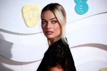 Margot Robbie poses for photographers upon arrival at the Bafta Film Awards, in central London, ...