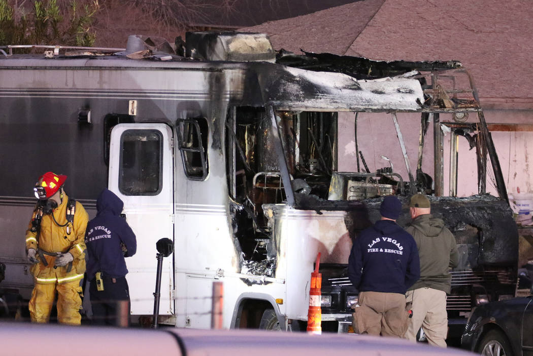 Las Vegas firefighters investigate the cause of a blaze in a recreational vehicle near West Bon ...