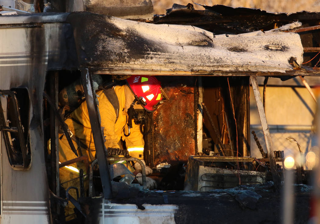 A Las Vegas firefighter investigates the cause of a blaze in a recreational vehicle near West B ...