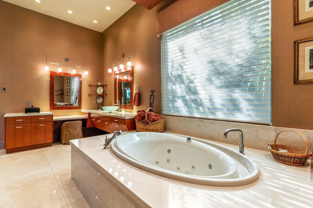The spa-like master bath features an oval tub, walk-in shower and dual sinks with a makeup stat ...