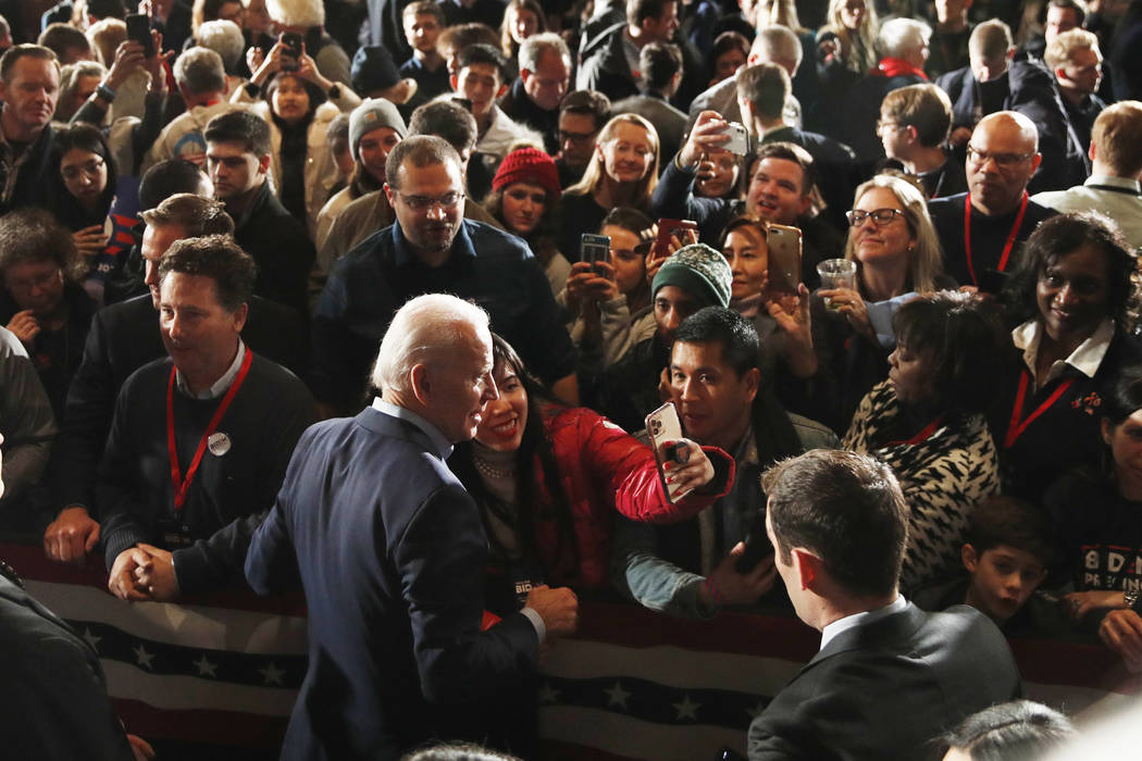 Democratic presidential candidate former Vice President Joe Biden walks in the crowd at a caucu ...