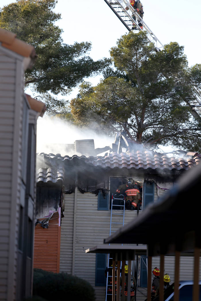 Fire crews work a blaze at Lantana Apartments on Charleston Boulevard near Torrey Pines Drive i ...