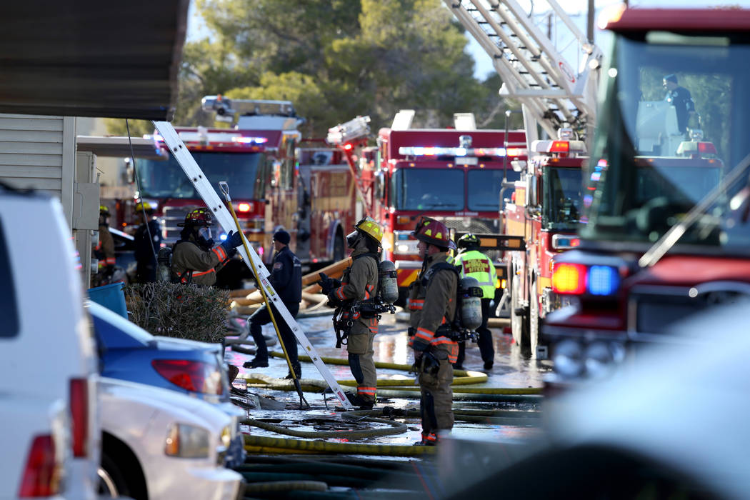 Fire crews work a blaze at Lantana Apartments on Charleston Boulevard near Torrey Pines Drive i ...