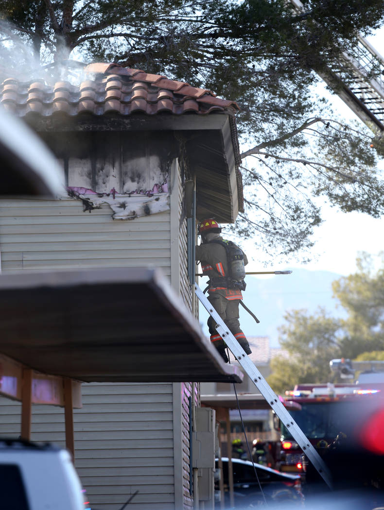 Fire crews work a blaze at Lantana Apartments on Charleston Boulevard near Torrey Pines Drive i ...