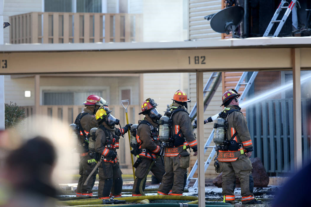 Fire crews work a blaze at Lantana Apartments on Charleston Boulevard near Torrey Pines Drive i ...