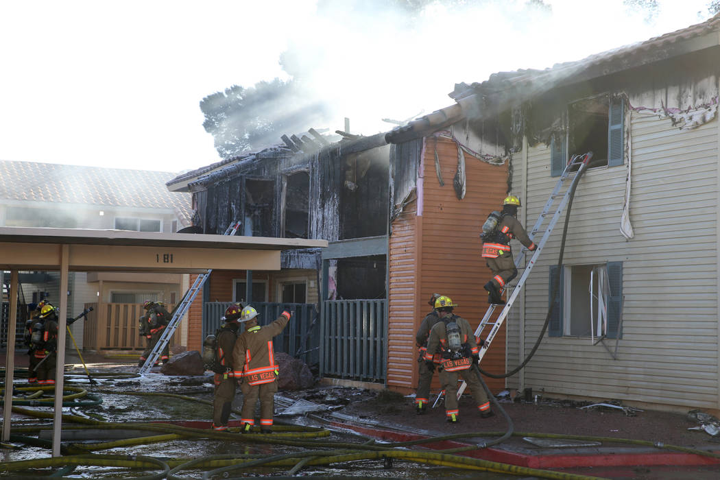 Fire crews work a blaze at Lantana Apartments on Charleston Boulevard near Torrey Pines Drive i ...