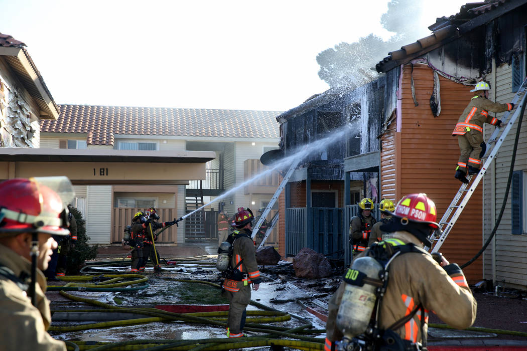 Fire crews work a blaze at Lantana Apartments on Charleston Boulevard near Torrey Pines Drive i ...