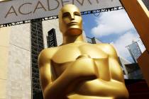 FILE - In this Feb. 21, 2015 file photo, an Oscar statue appears outside the Dolby Theatre for ...