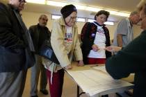 Searchlight residents Caryn Hollingsworth, at table left, and Kriss Haring sign up for the Neva ...