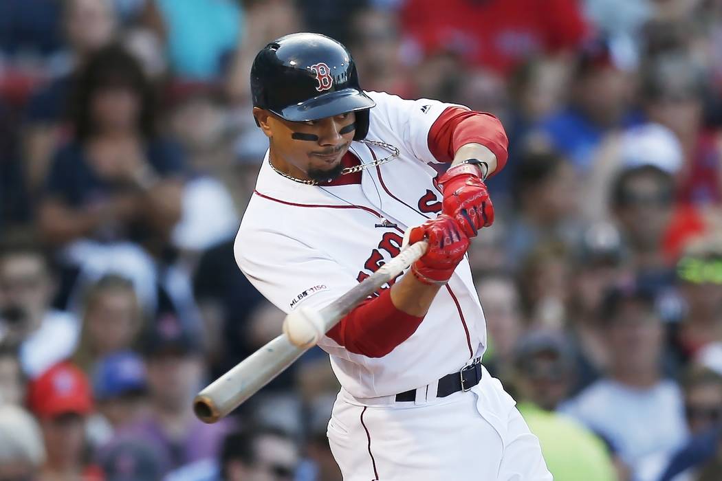 Boston Red Sox's Mookie Betts hits an RBI-double during the sixth inning of a baseball game aga ...