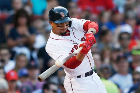 Boston Red Sox's Mookie Betts hits an RBI-double during the sixth inning of a baseball game aga ...