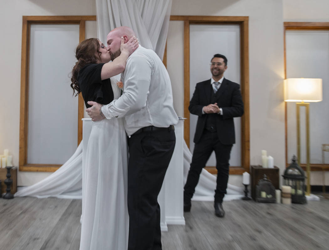 Jordan Williams, middle, 30, and Amanda Schild, 33, from Rochester, Minn., kiss at the conclusi ...