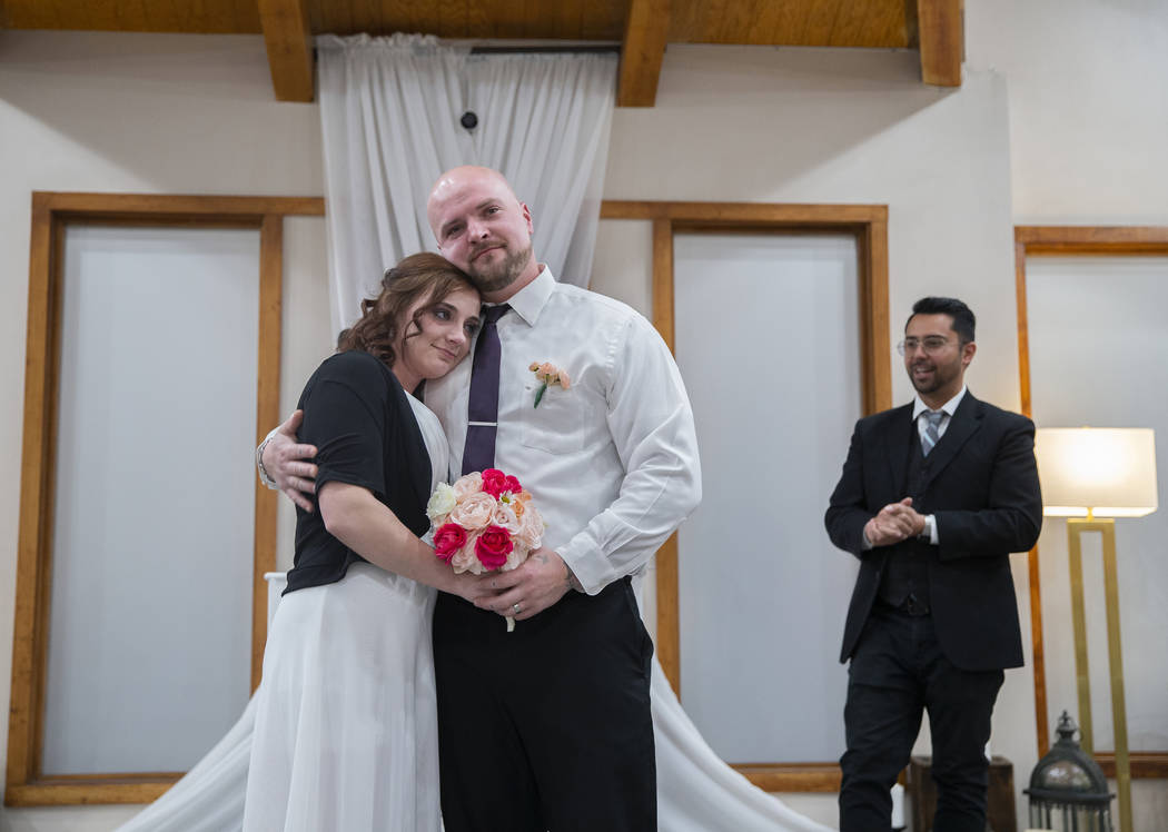 Jordan Williams, middle, 30, and Amanda Schild, 33, from Rochester, Minn., share a hug at the c ...
