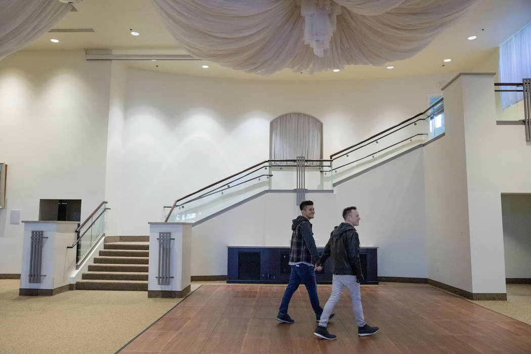 Las Vegas locals Sam Cruz, left, and Jeff Gaglione look at their future wedding venue at Emeral ...