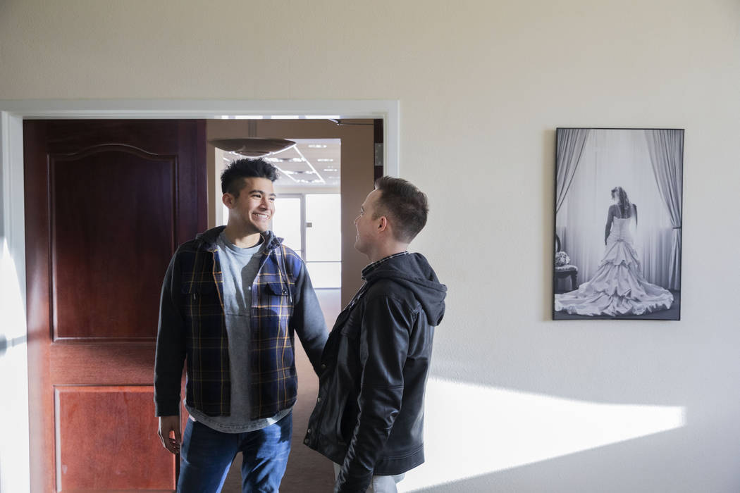 Las Vegas locals Sam Cruz, left, and Jeff Gaglione look enter the bridal suite of their future ...