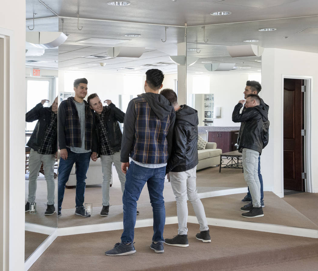 Las Vegas locals Sam Cruz, left, and Jeff Gaglione look in the mirror and talk about their wedd ...