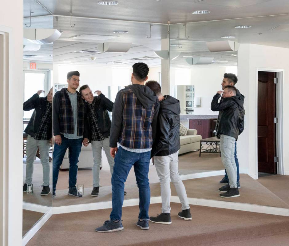 Las Vegas locals Sam Cruz, left, and Jeff Gaglione look in the mirror and talk about their wedd ...