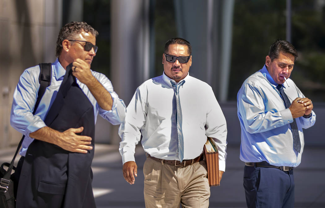 Counselor Mark Fleming, left, walks out with defendant Albert Lopez past defendant Bradley Camp ...