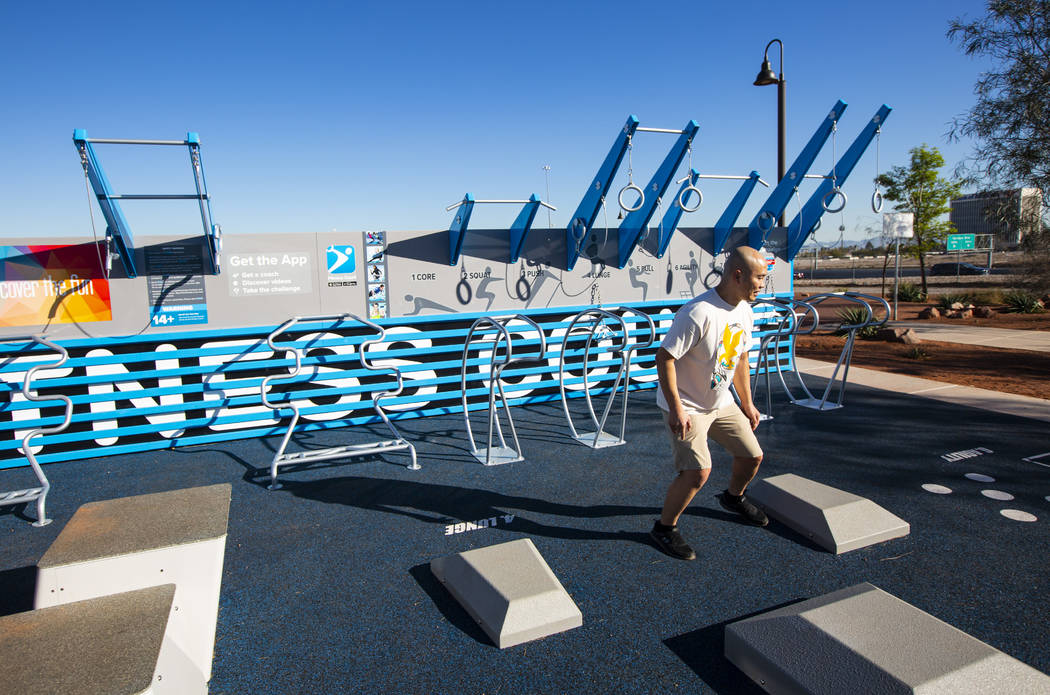 Local resident Malig Williams tries out the new Fitness Court at Bill Briare Family Park in Las ...