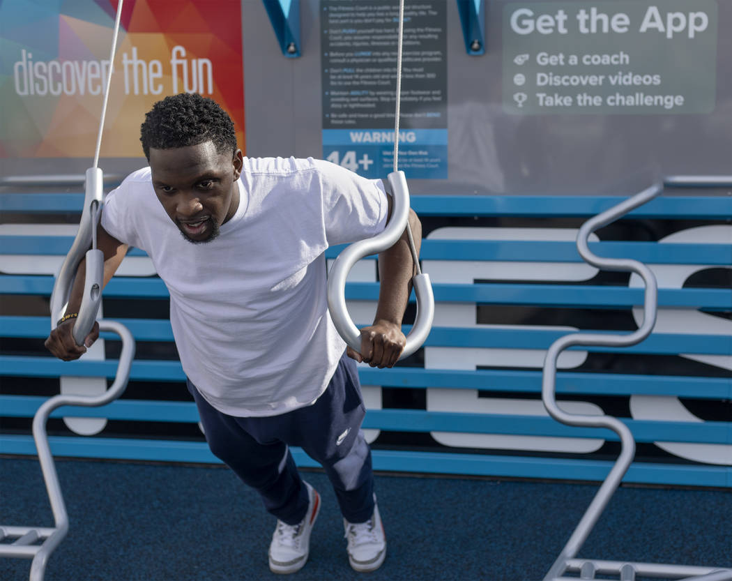 Las Vegas Parks and Recreation manager Savonta Manor tests out the new outdoor Fitness Court by ...