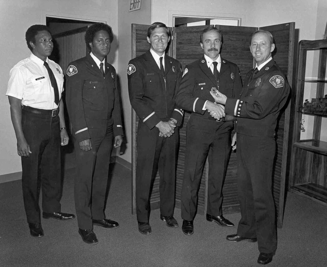 From left, Monroe Williams and Bill Young are promoted to fire captain by Fire Chief Sam Cooper ...