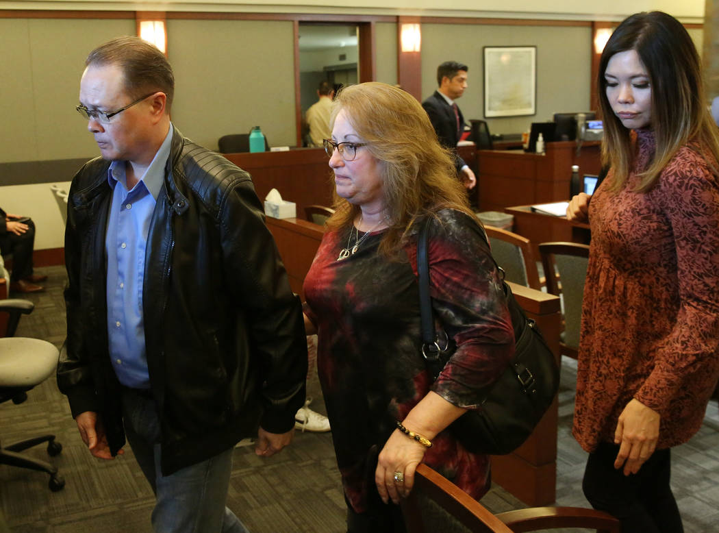 Theresa Christensen, center, mother of Lee's Liquor robbery victim Matthew Christensen, 24, and ...