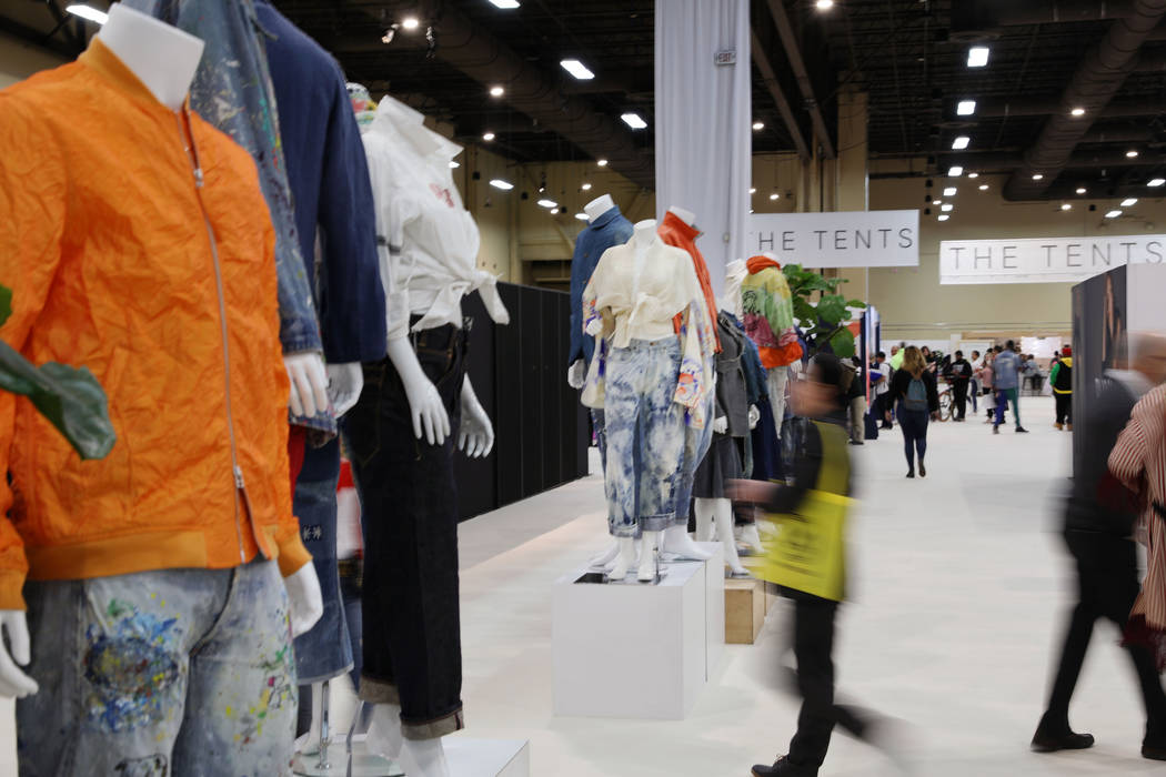 Attendees walk through the dual-gender contemporary Denim Room at Project during the opening mo ...