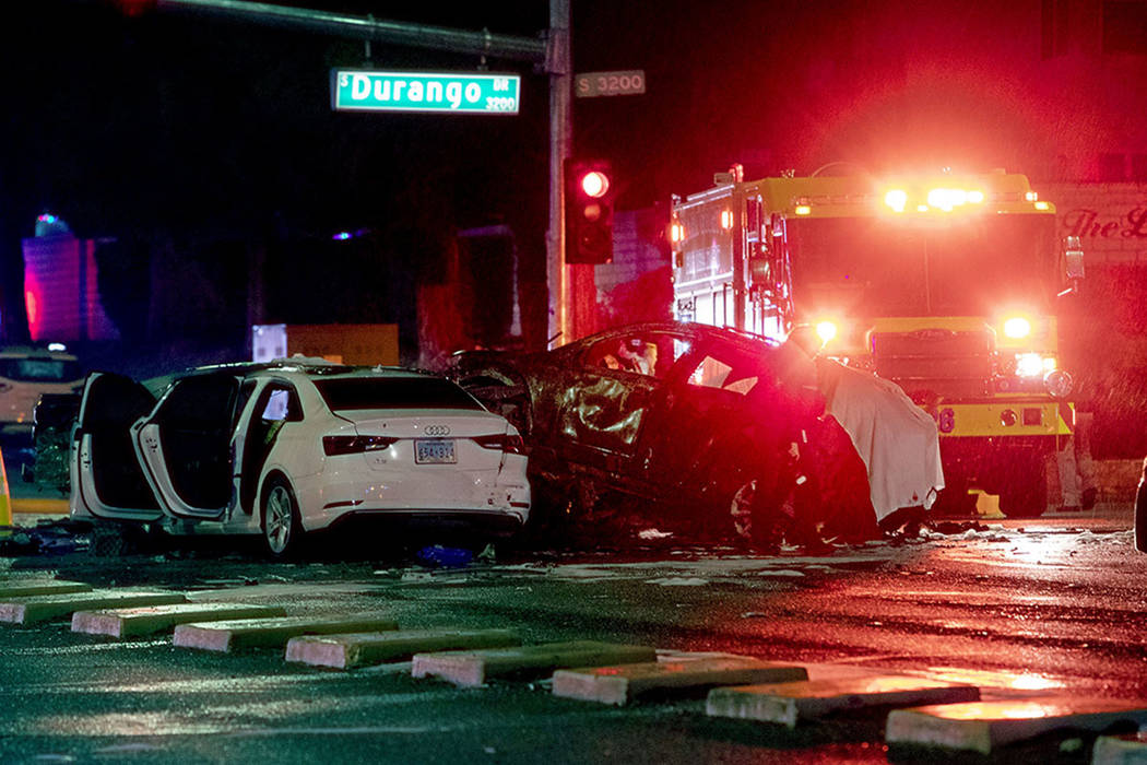 Police and fire crews investigate a fatal crash, Dec. 26, 2019, at the intersection of West Des ...