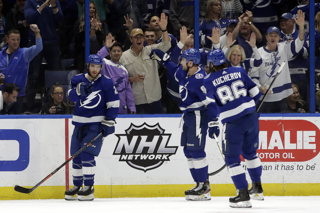 Tampa Bay Lightning center Brayden Point (21) celebrates with center Steven Stamkos (91) and ri ...