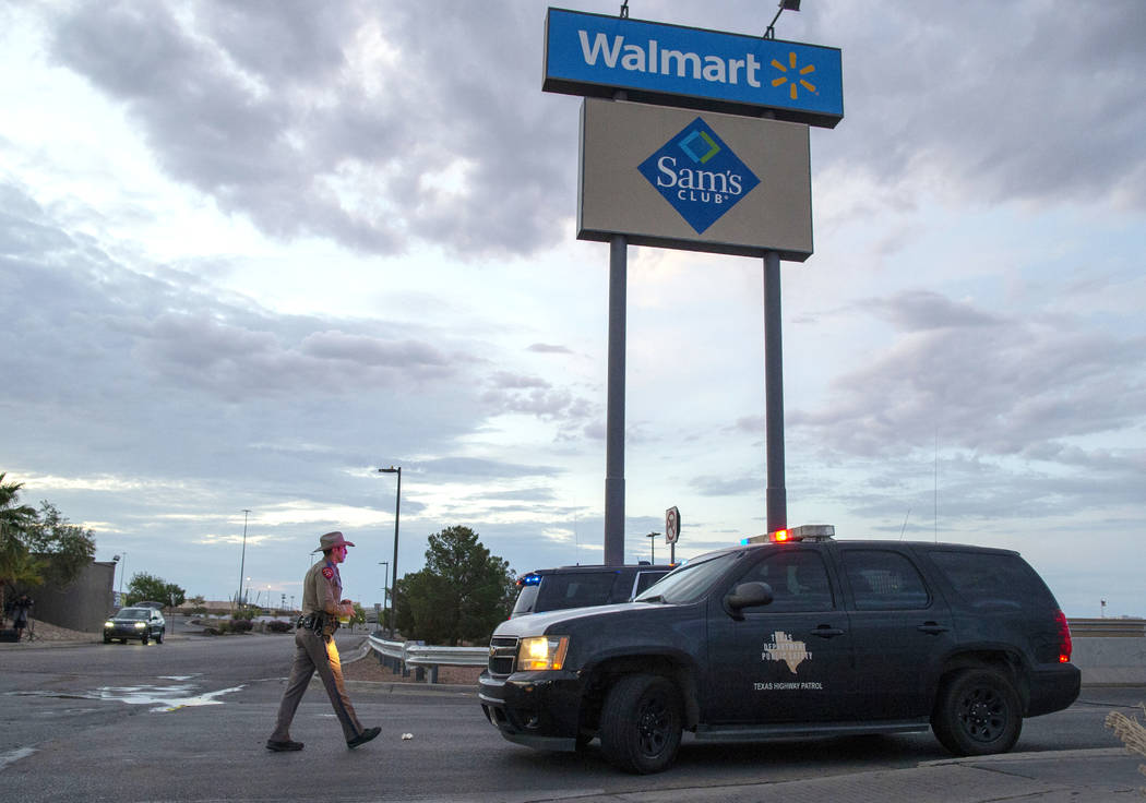 FILE - In this Aug. 4, 2019 file photo, a Texas State Trooper walks back to his car while provi ...