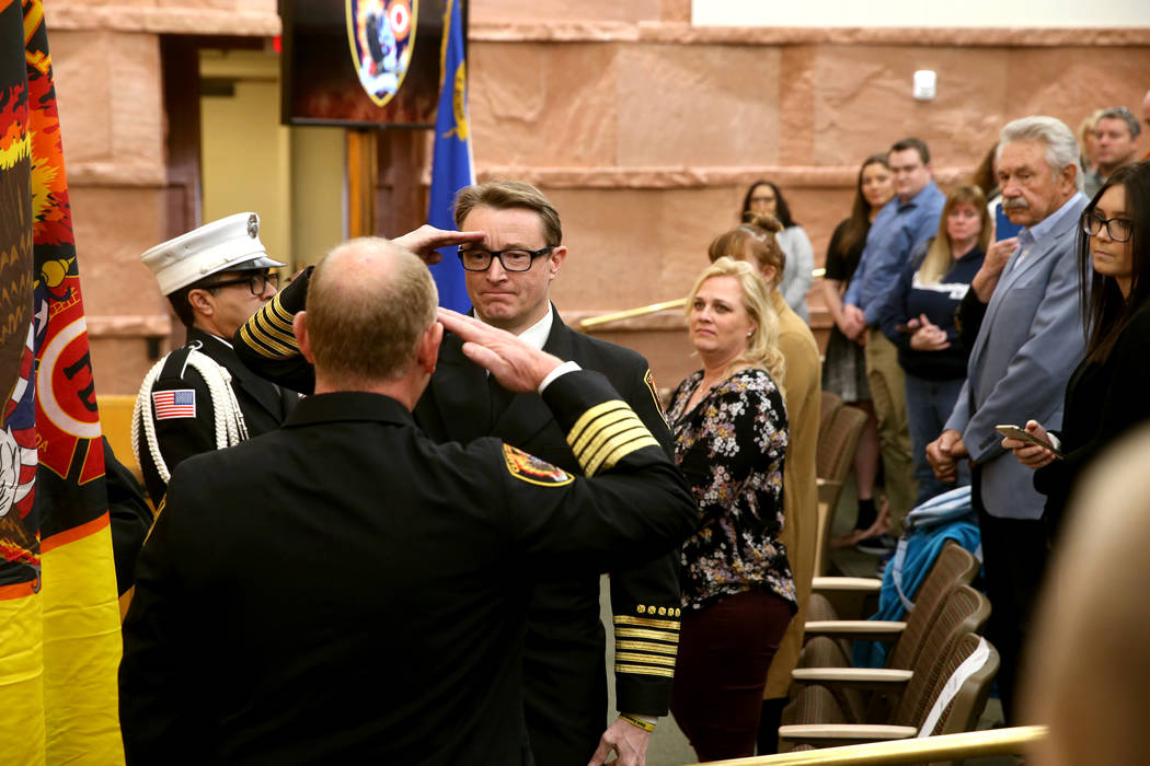 Outgoing Clark County Fire Department Chief Greg Cassell, left, turns over command of the depar ...