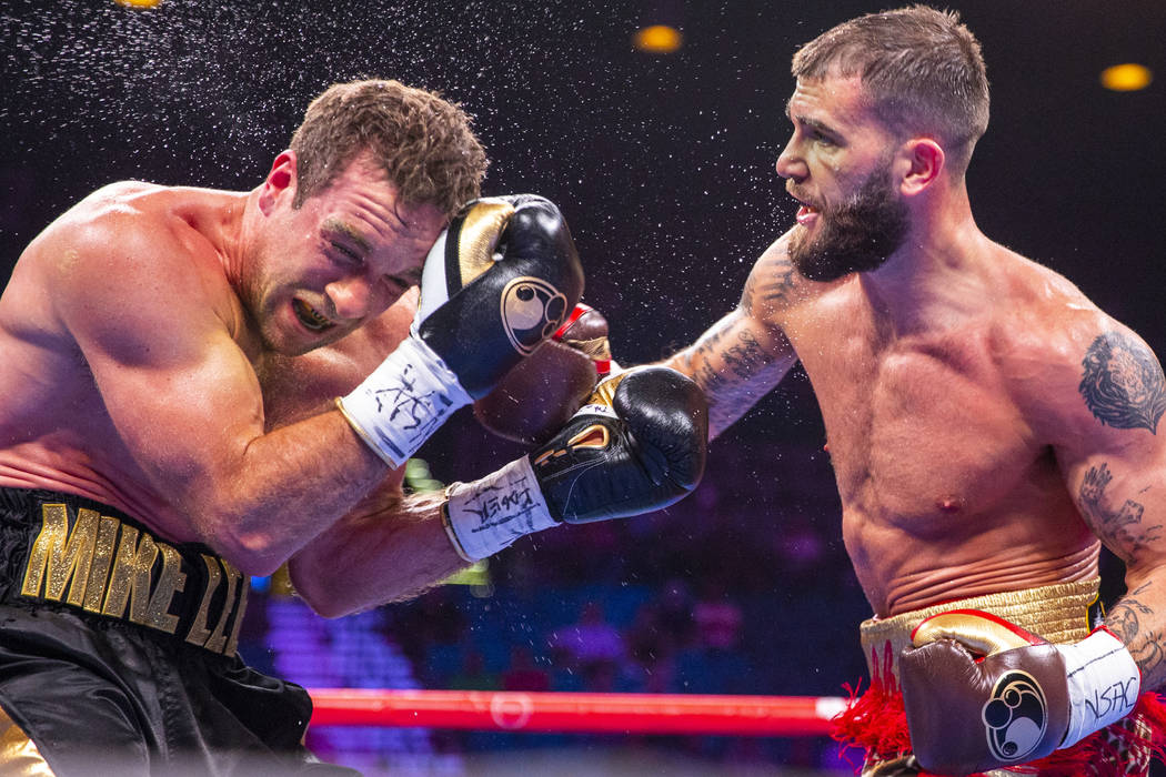 Mike Lee, left, takes a punch to the face from Caleb Plant which sends him to the canvas again ...