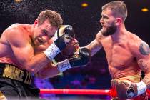 Mike Lee, left, takes a punch to the face from Caleb Plant which sends him to the canvas again ...