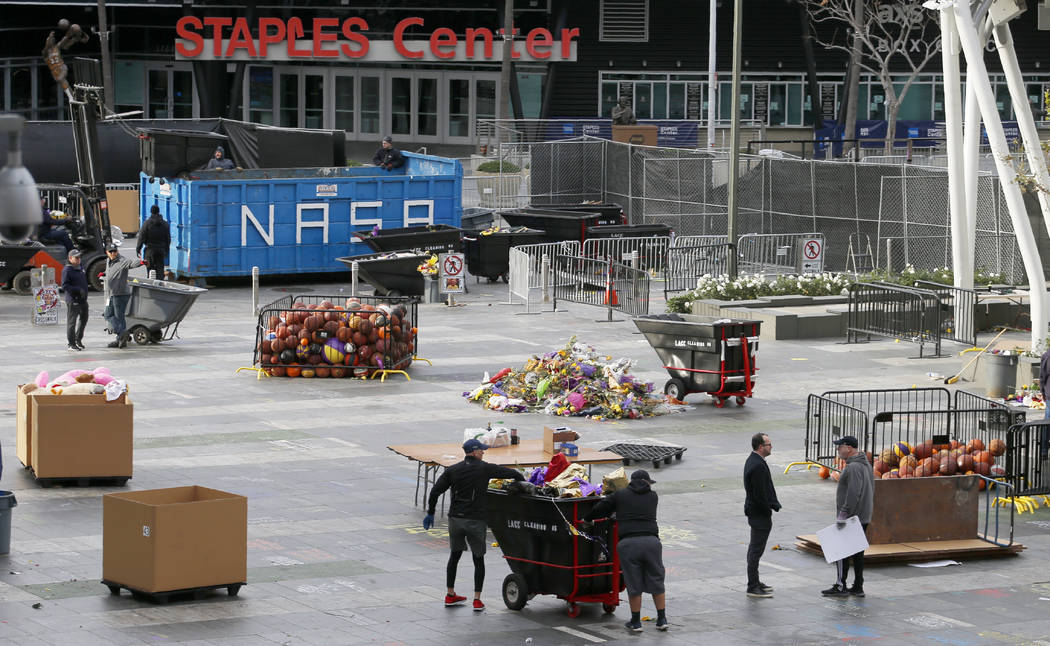 Workers remove thousands of items left in honor of Kobe Bryant, including hundreds of basketbal ...