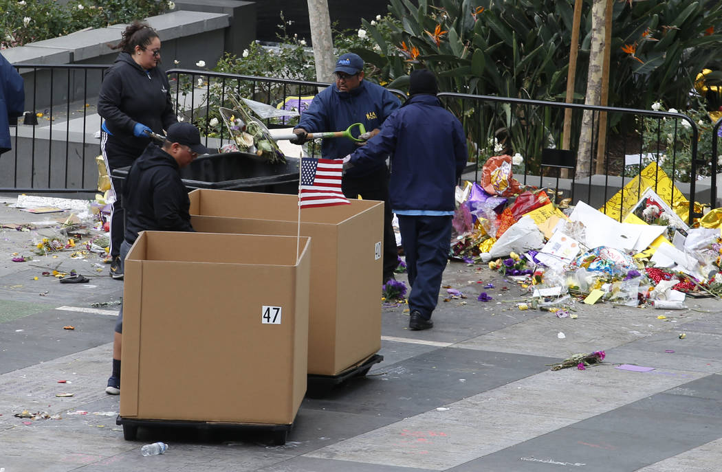 Workers remove thousands of items left in honor of Kobe Bryant, including hundreds of basketbal ...