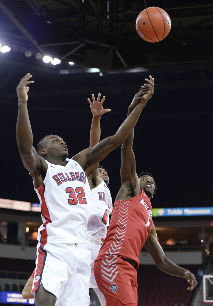 Fresno State's Nate Grimes, left, and New Mexico's Corey Manigault reach for a loose ball durin ...