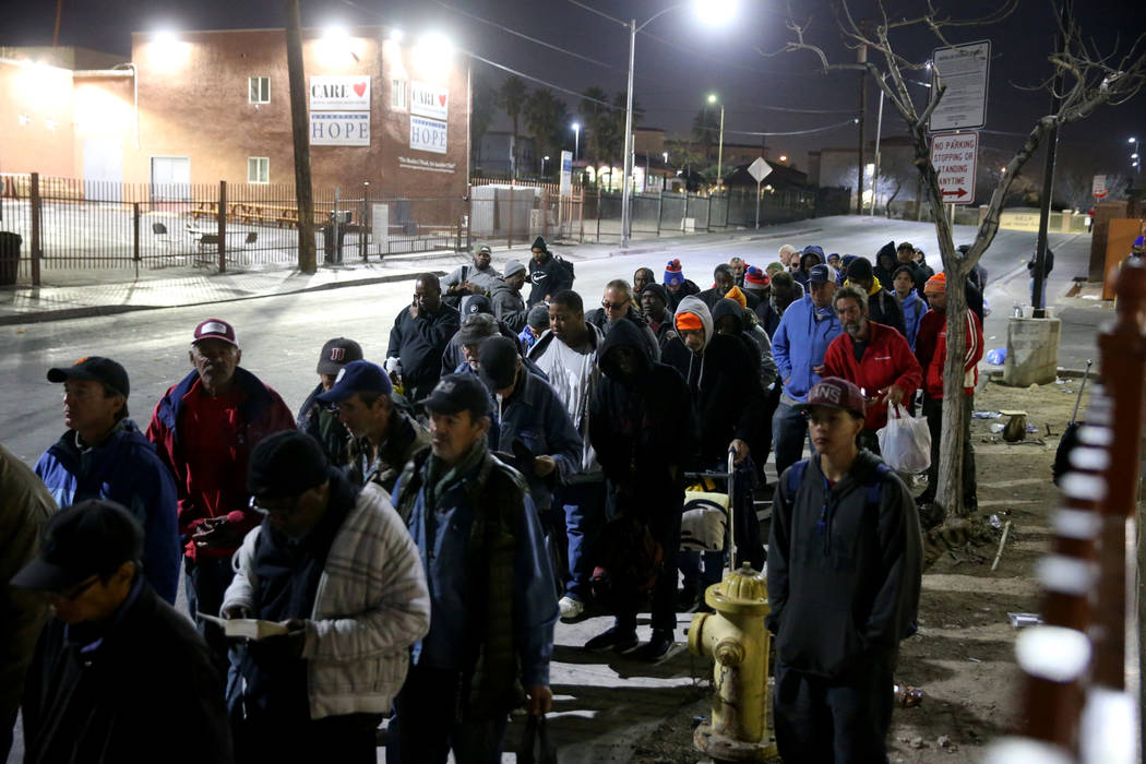 People line up for the overnight shelter beds at Catholic Charities in Las Vegas Thursday, Feb. ...