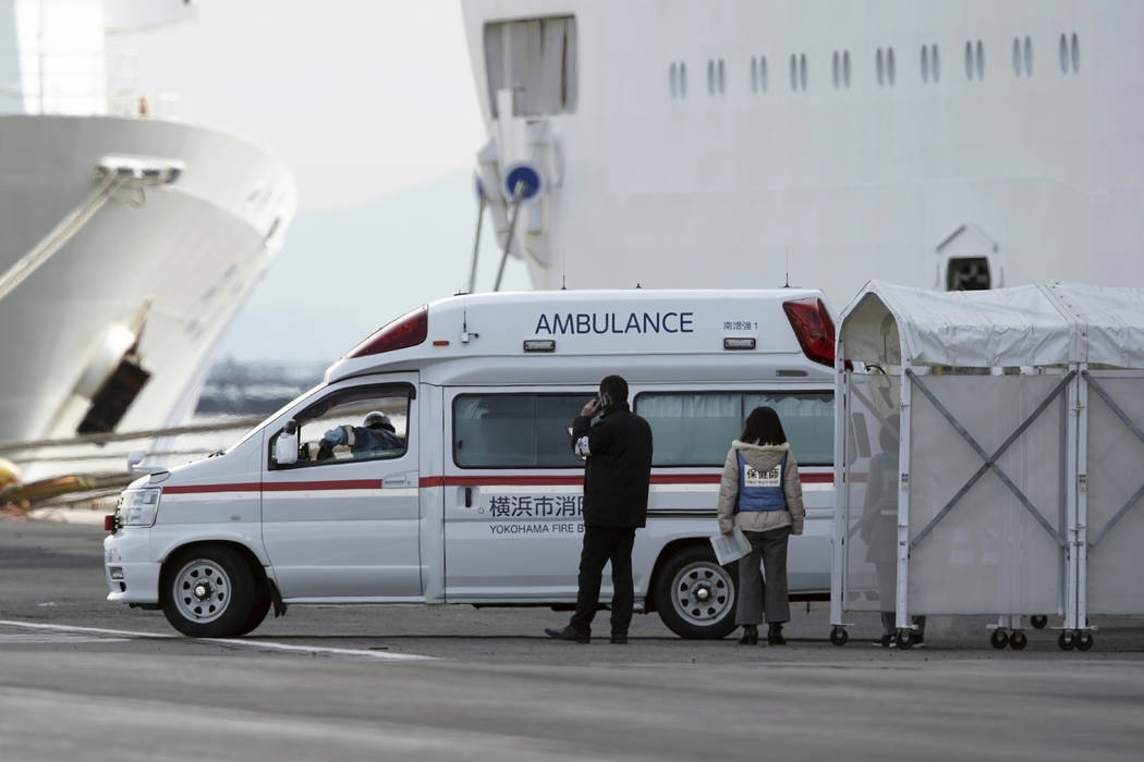 An ambulance arrives at the cruise ship Diamond Princess anchored at Yokohama Port in Yokohama, ...