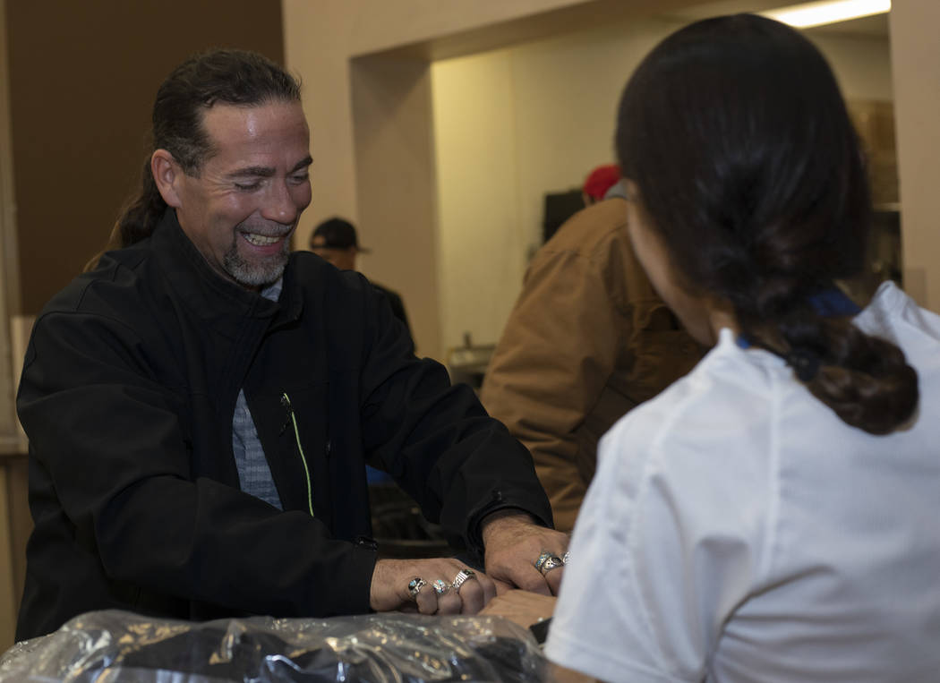 Bruce Thompson picks up his free CITYPAK backpack at the Las Vegas Rescue Mission on Saturday, ...