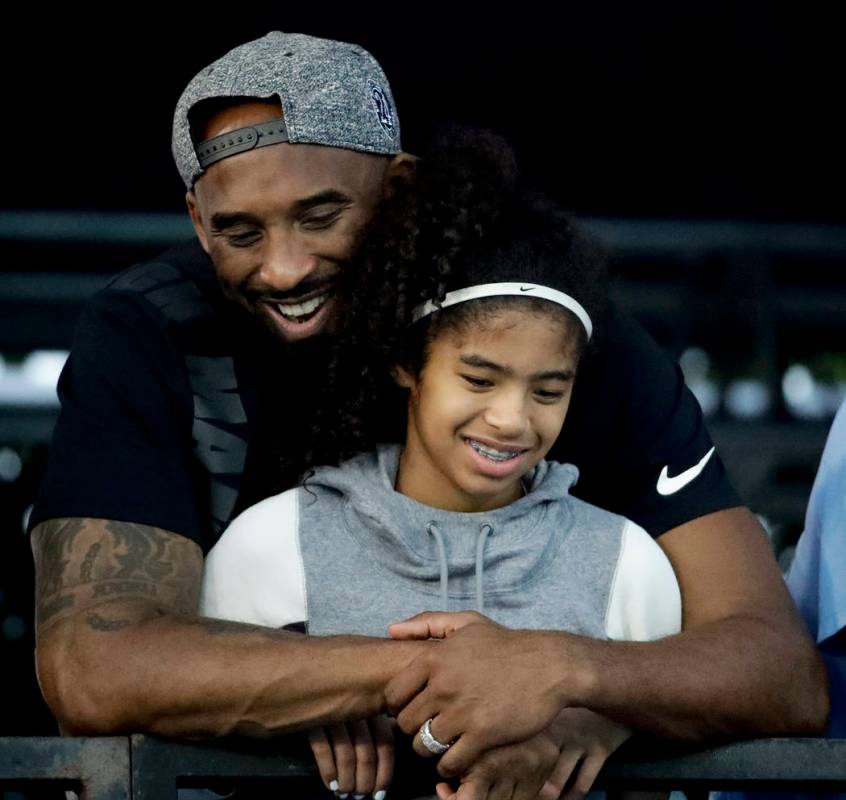 Former Los Angeles Laker Kobe Bryant and his daughter Gianna watch during the U.S. national cha ...