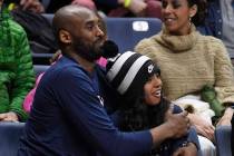 Kobe Bryant and his daughter Gianna watch the first half of an NCAA college basketball game bet ...