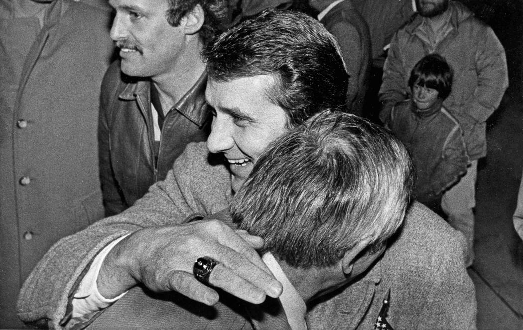 U.S. Olympic hockey coach Herb Brooks gives a hugs to University of Minnesota athletic director ...
