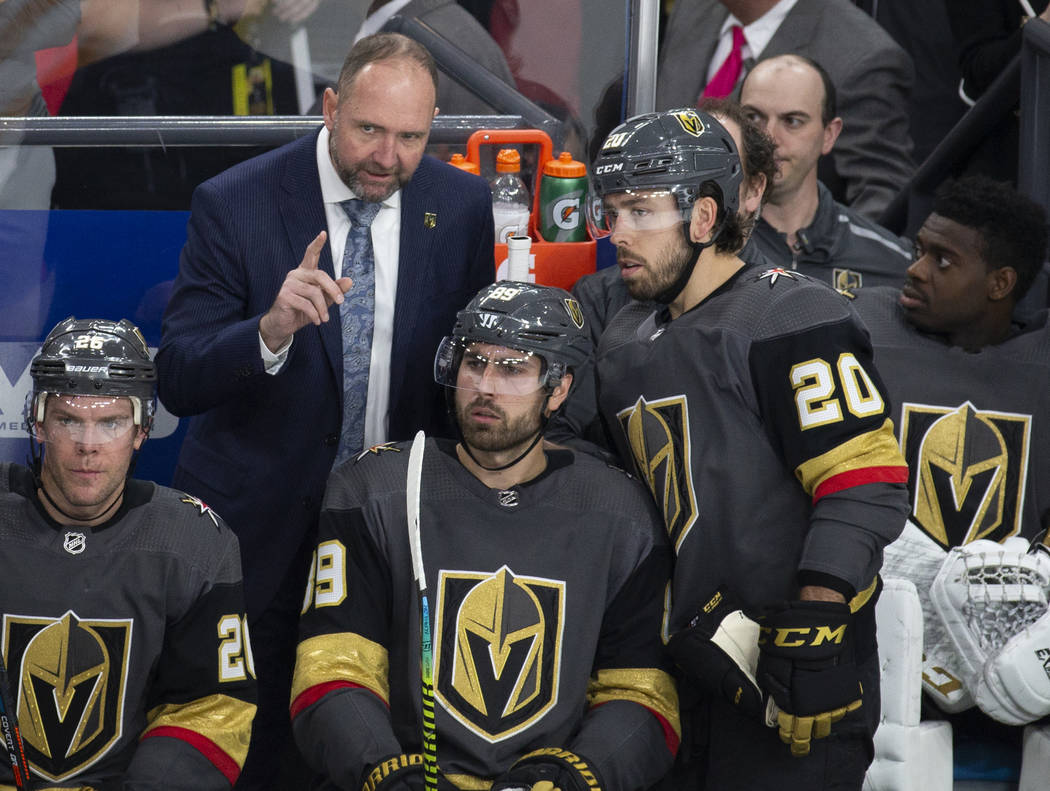 Golden Knights head coach Peter DeBoer talks with Vegas Golden Knights center Chandler Stephens ...