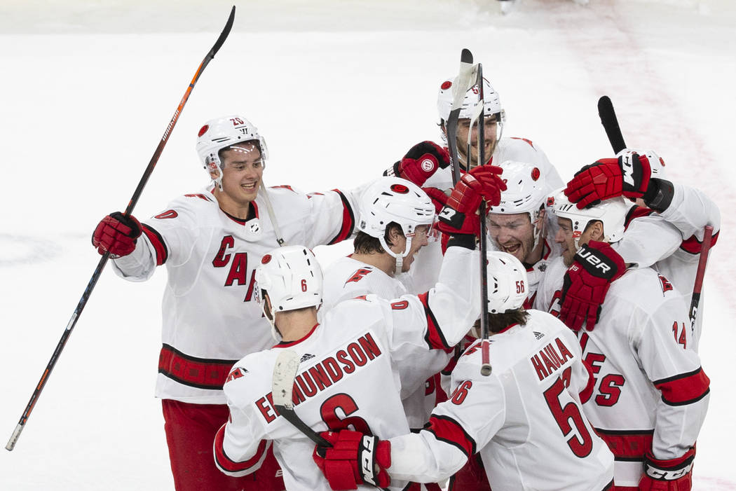 Carolina Hurricanes players celebrate after beating the Golden Knights 6-5 in a shoutout during ...