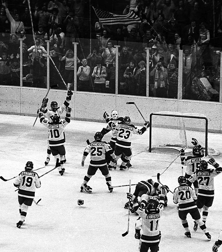 FILE - In this Feb. 22, 1980, file photo, The United States ice hockey team rushes toward goali ...