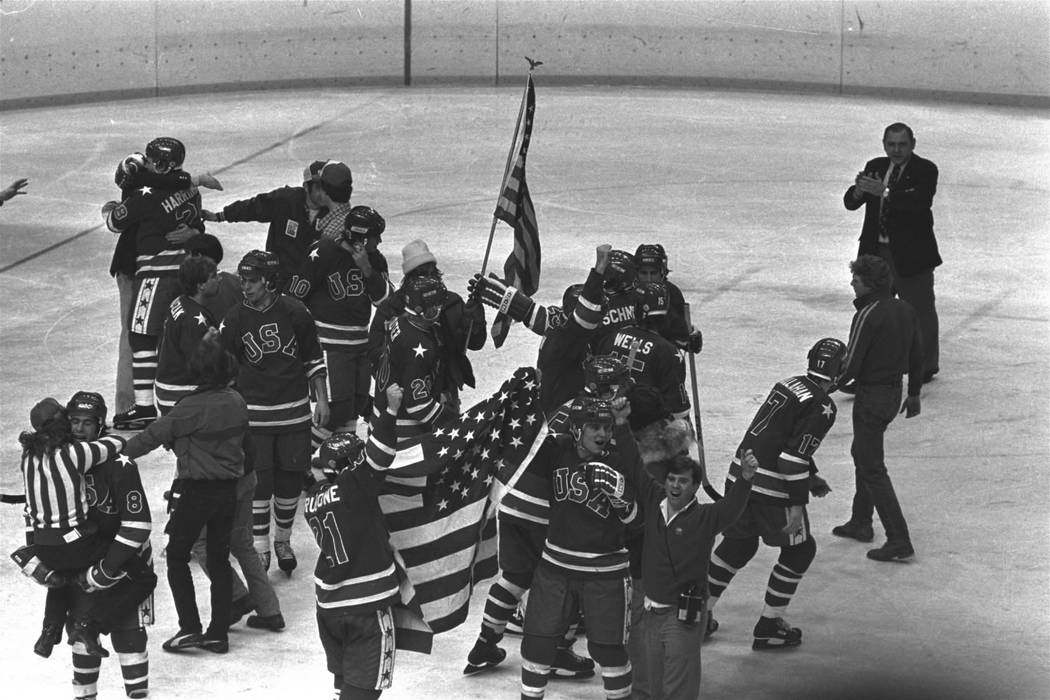 Members of the U.S. Olympic ice hockey team whoop it up on ice at the arena after winning the g ...