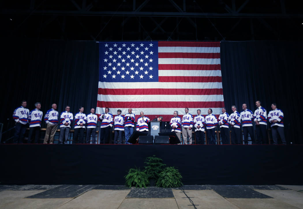 Members of the 1980 U.S. ice hockey team stand on stage during a "Relive the Miracle" reunion a ...