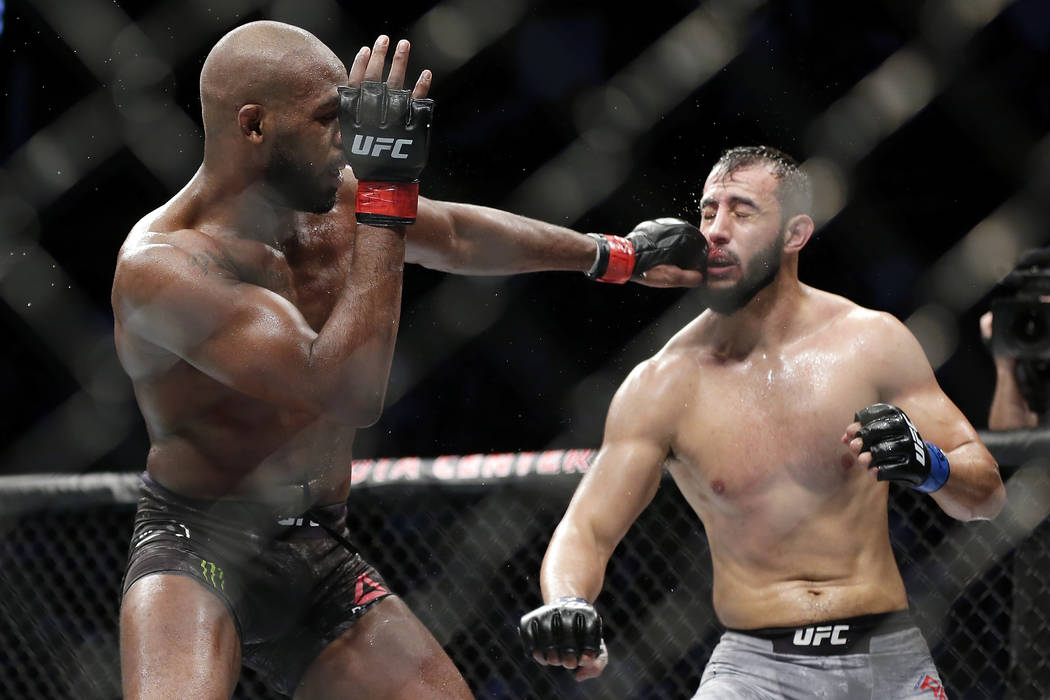 Jon Jones, left, connects with a punch to the face of Dominick Reyes, right, during a light hea ...